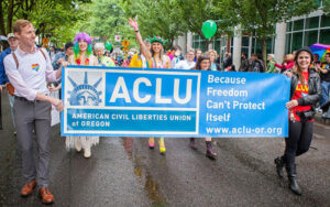 People marching with an ACLU banner