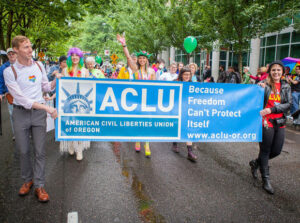 People marching with an ACLU banner